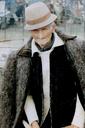 An older gentlemen in a fabulous wool jacket and sporting his best hat.